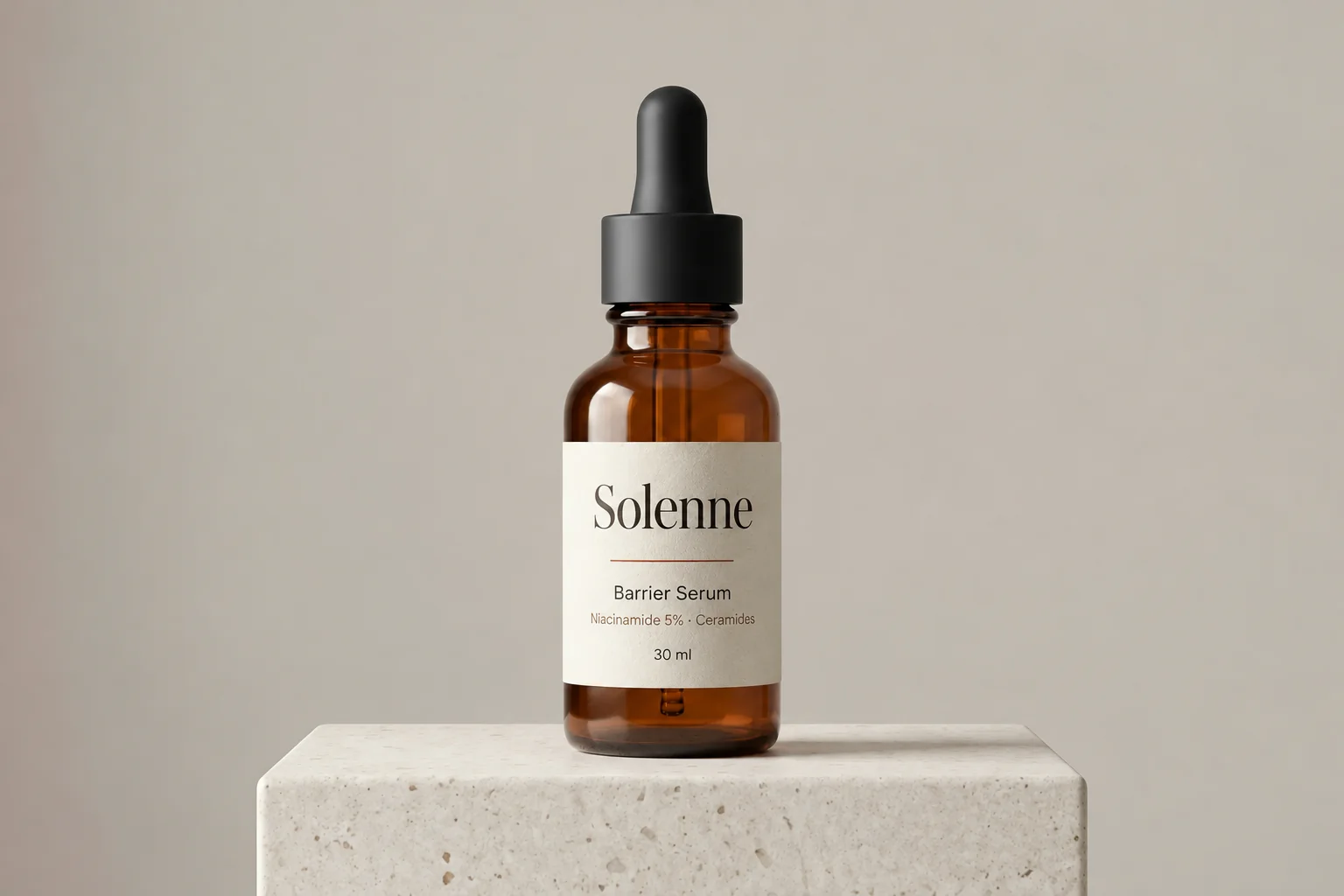 A Solenne Barrier Serum dropper bottle standing on a stone block