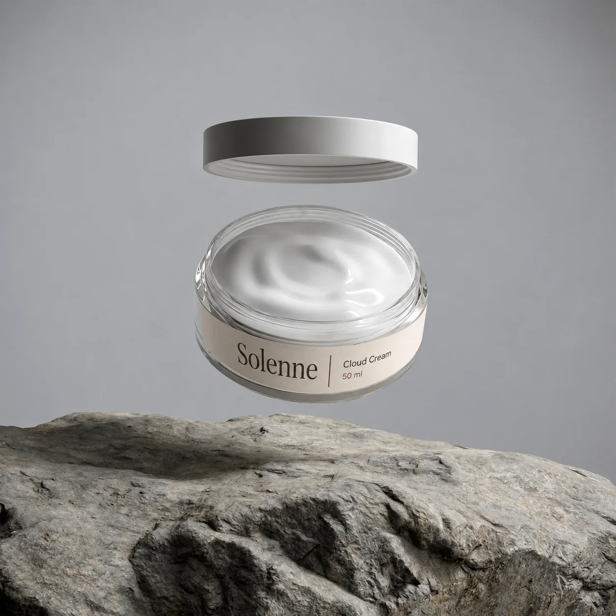 A jar of Cloud Cream with its lid floating above it, over a rock