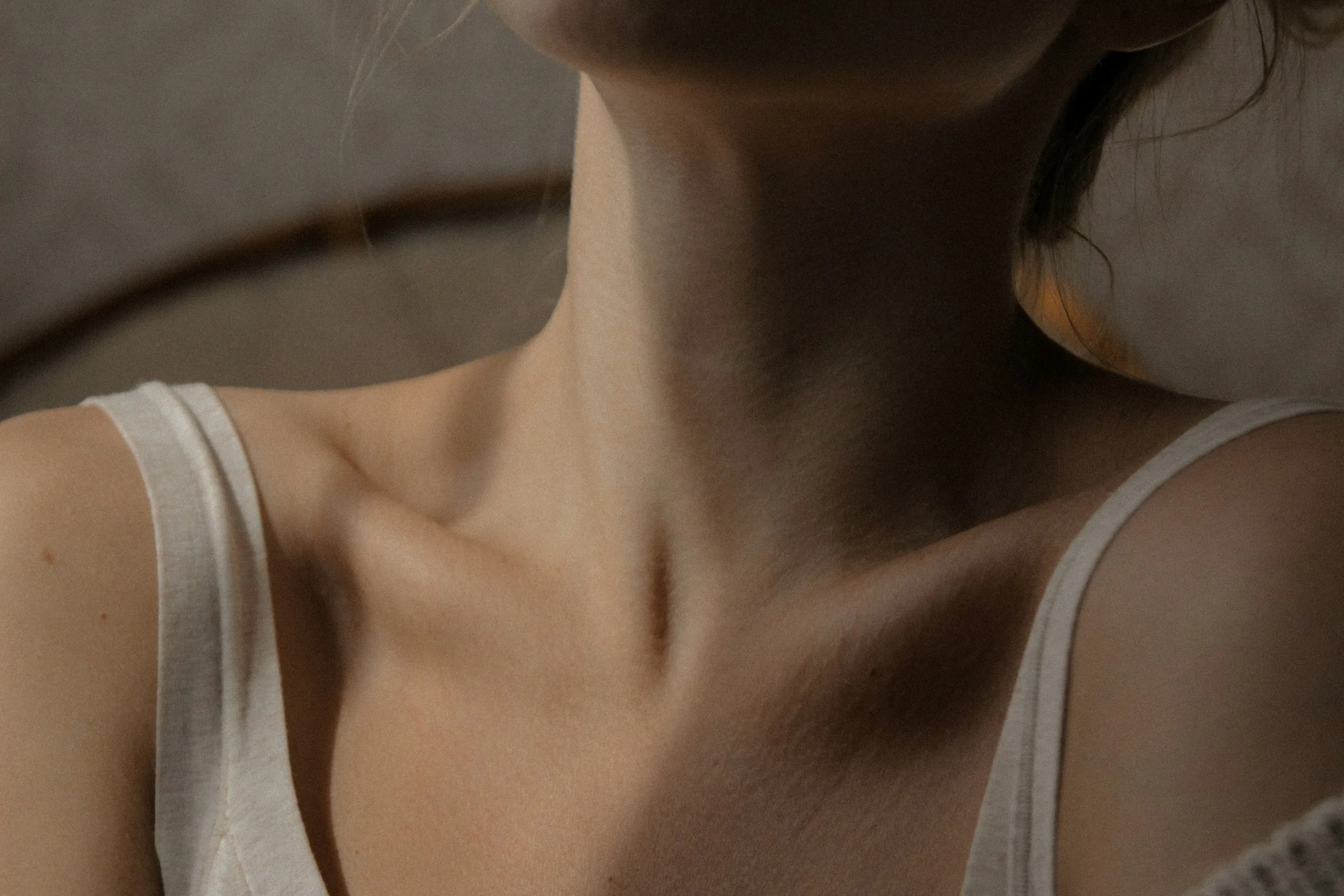 Soft light across a collarbone and shoulder