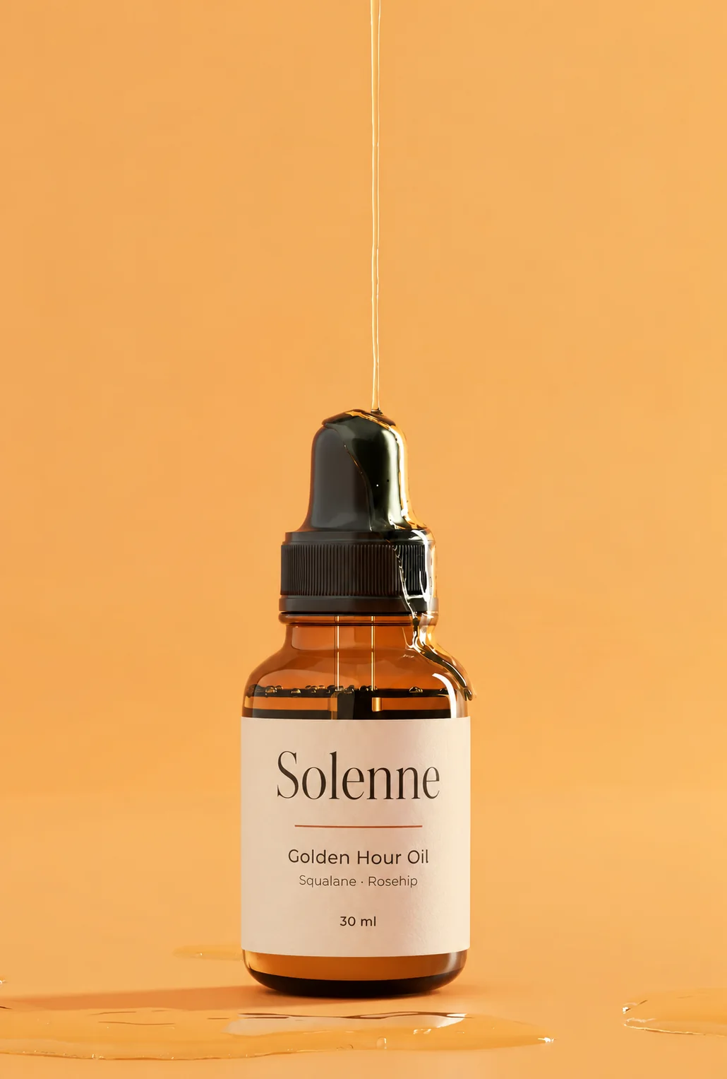 A Golden Hour Oil bottle with oil running down its dropper, against a warm golden background