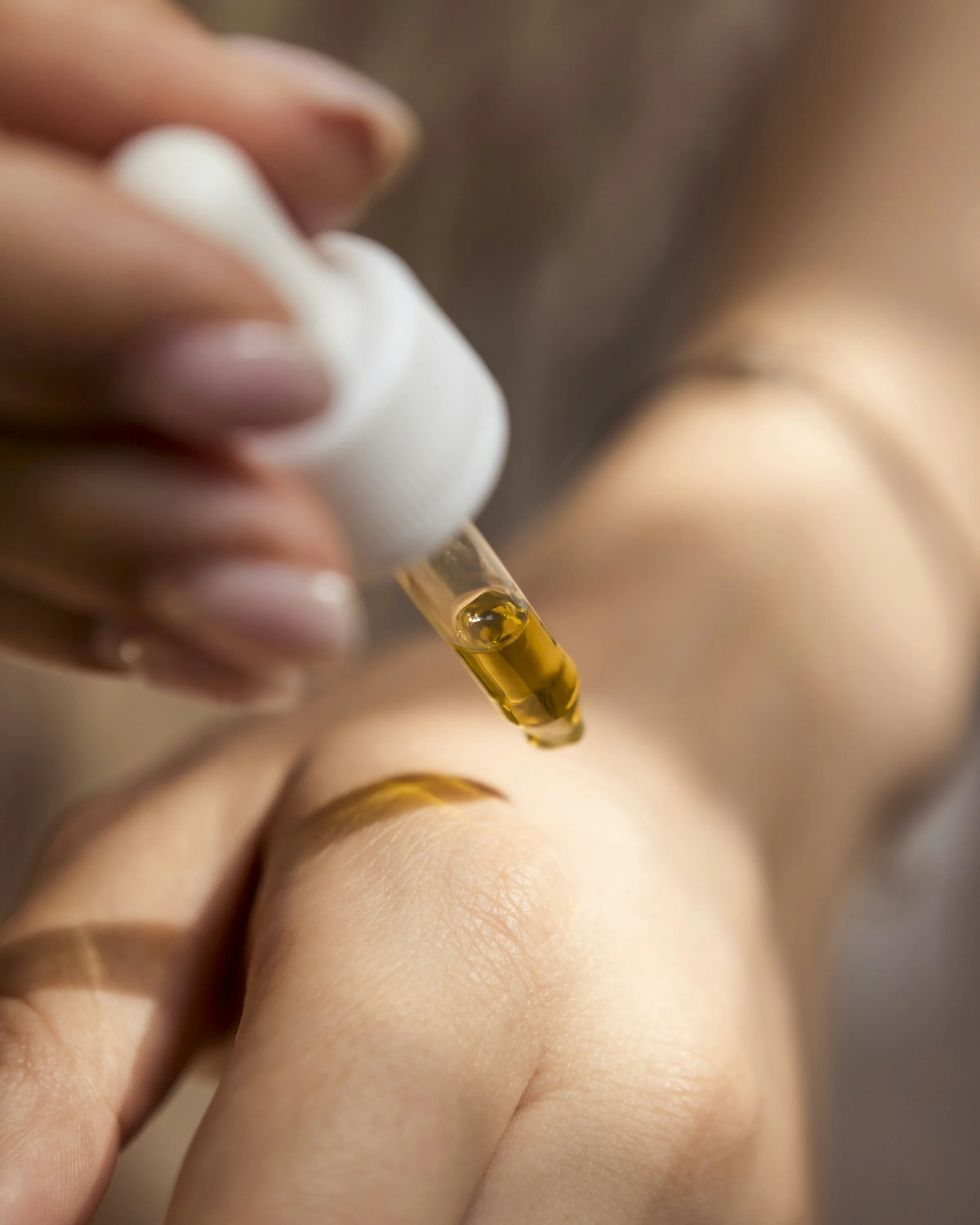 Golden oil falling into an open palm